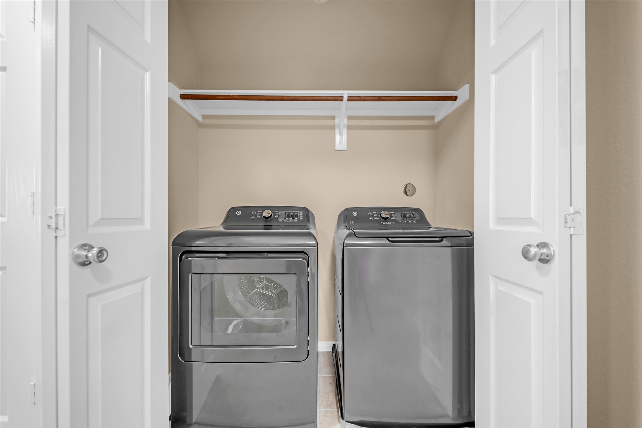 5406 Quarry Ridge Road Richmond, TX 77407 - Photo 28 of 36 Convenient upstairs laundry room located near the secondary bedrooms for added everyday efficiency. Features dedicated utility shelving and space for a full-size washer and dryer. The newer washer and dryer shown are available for purchase separately and are not included with the sale.