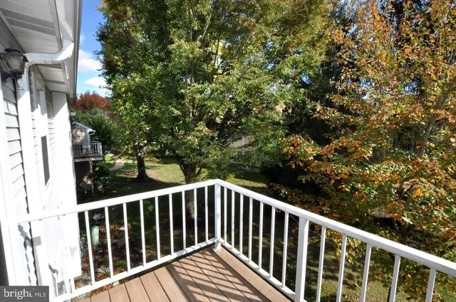 a view of balcony with wooden floor and fence
