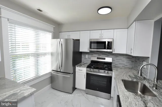 a kitchen with a refrigerator stove and microwave