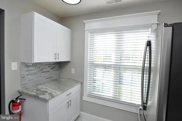 a kitchen with a window a sink and cabinets