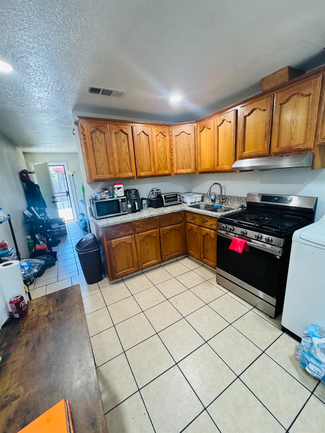 1335 Olive Avenue Sanger, CA 93657 - Photo 12 of 28 a kitchen with a sink a stove and cabinets