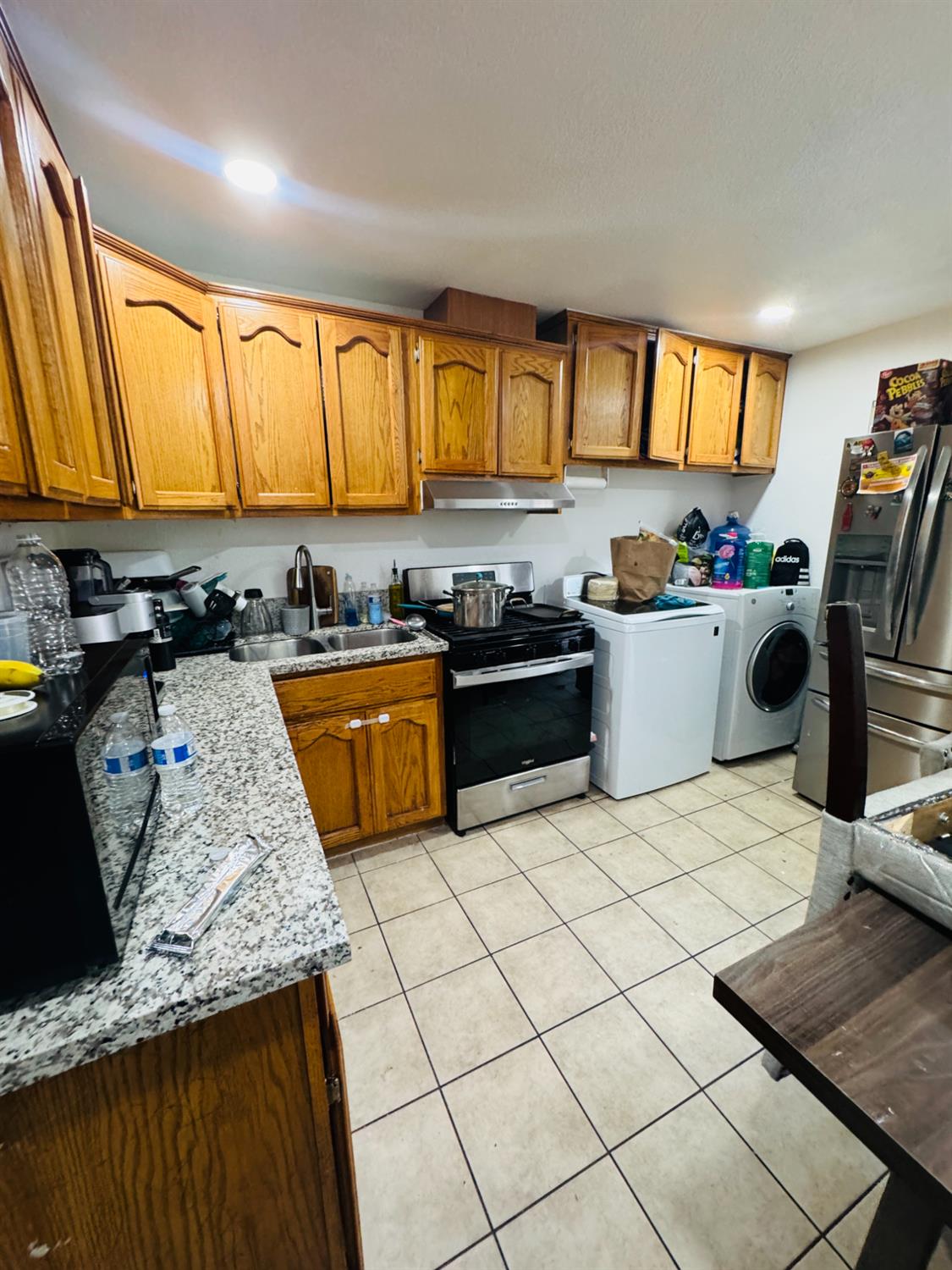 1335 Olive Avenue Sanger, CA 93657 - Photo 16 of 28 a kitchen with a sink a stove and cabinets