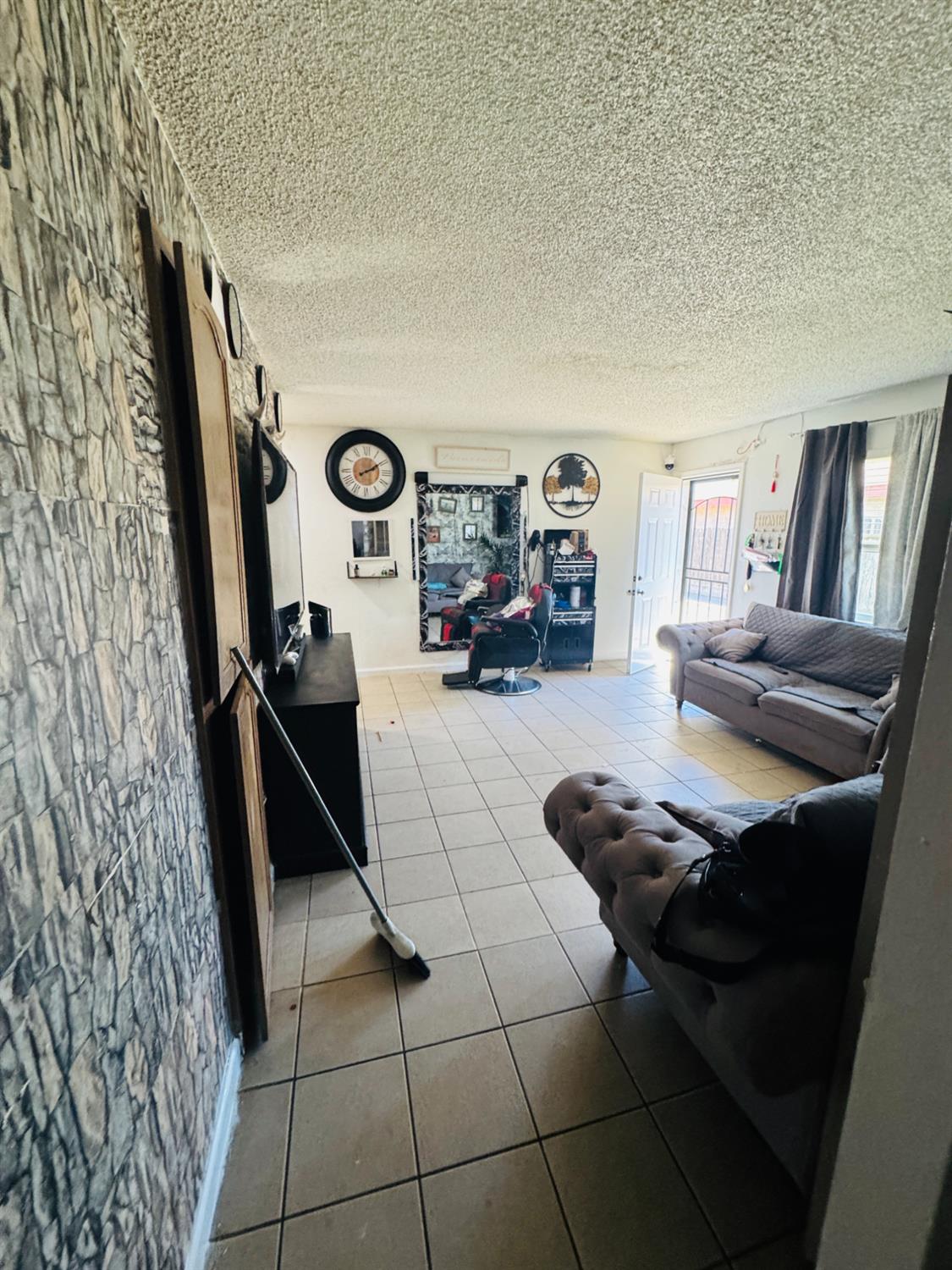 1335 Olive Avenue Sanger, CA 93657 - Photo 18 of 28 a living room with furniture and a rug