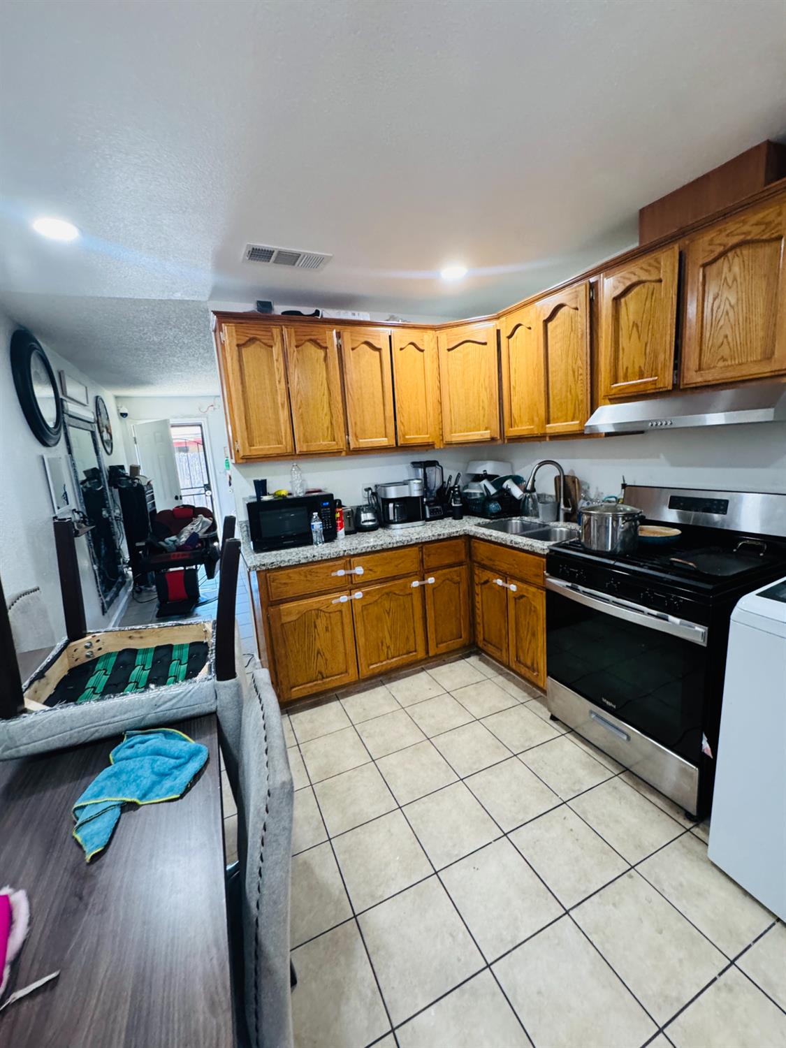 1335 Olive Avenue Sanger, CA 93657 - Photo 19 of 28 a kitchen with stainless steel appliances granite countertop a sink and cabinets