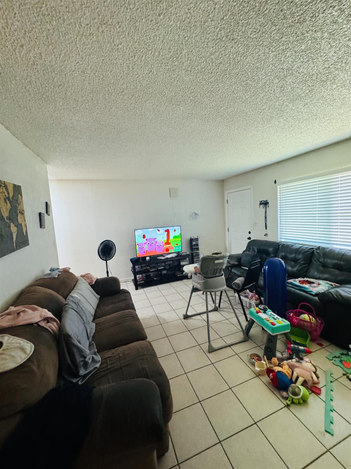 1335 Olive Avenue Sanger, CA 93657 - Photo 23 of 28 a living room with furniture and a flat screen tv