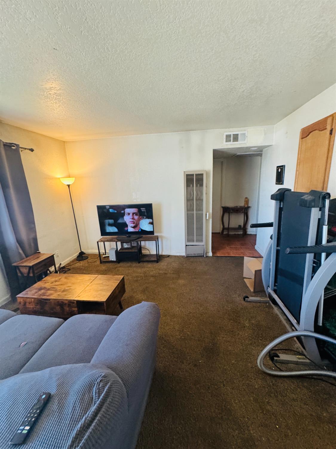 1335 Olive Avenue Sanger, CA 93657 - Photo 7 of 28 a room with furniture and a flat screen tv