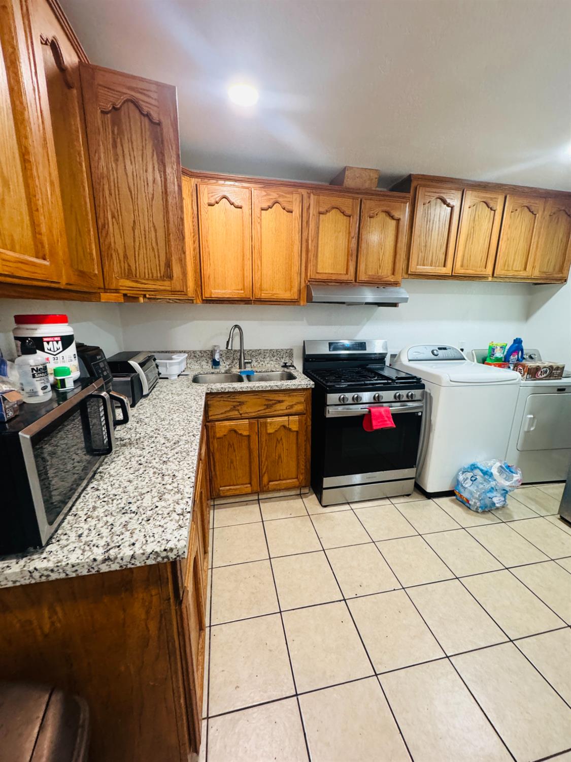 1335 Olive Avenue Sanger, CA 93657 - Photo 9 of 28 a kitchen with a sink a stove and cabinets