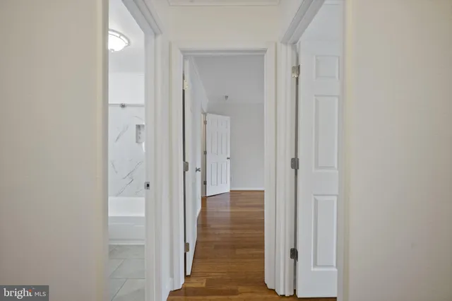 a view of a hallway with wooden floor