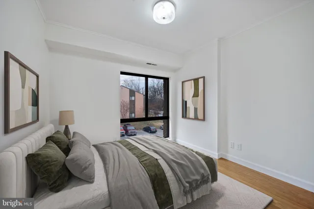 a bedroom with a bed and window