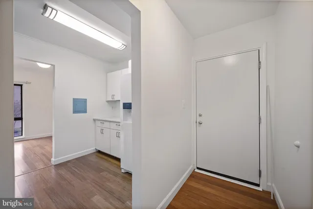 a view of a kitchen with a sink and a refrigerator