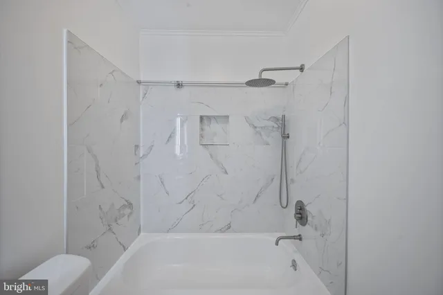 a bathroom with a bathtub and shower