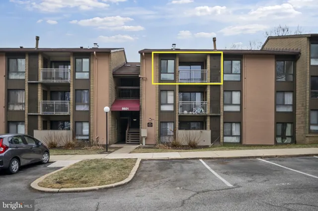 a view of a white house with large windows