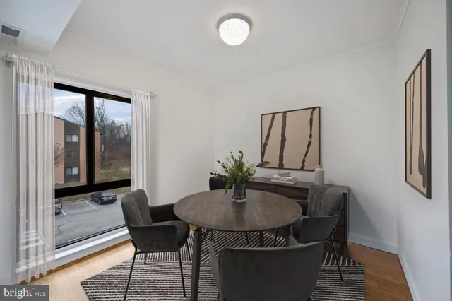 a view of a dining room with furniture and window