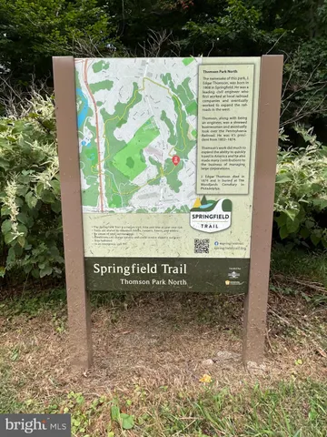 a view of outdoor space with a garden and signage