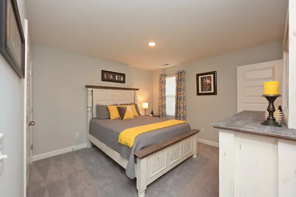 a bedroom with a bed and dresser