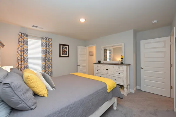 a bathroom with a sink a toilet a mirror and shower curtain