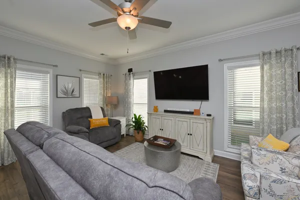 a living room with furniture fireplace and a flat screen tv