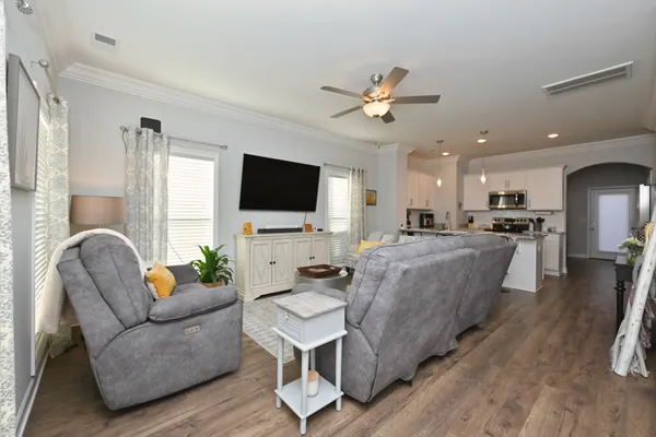 a living room with furniture and a chandelier