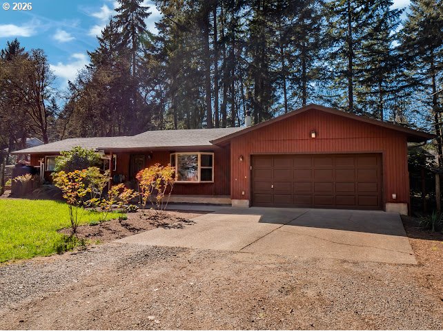 87974 8th Street Veneta, OR 97487 - Photo 1 of 48 a front view of a house with a yard and garage