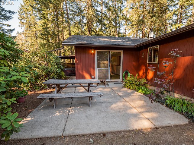 87974 8th Street Veneta, OR 97487 - Photo 17 of 48 a view of patio with a table and chairs under an umbrella