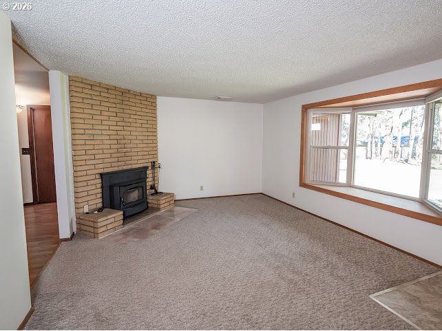 87974 8th Street Veneta, OR 97487 - Photo 20 of 48 an empty room with fireplace and windows
