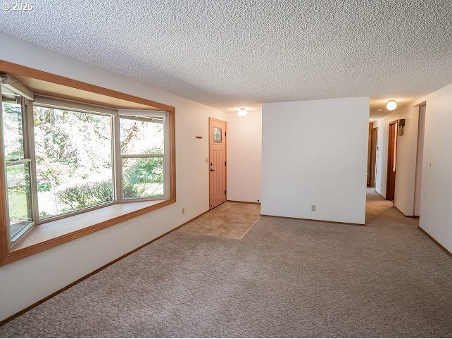 87974 8th Street Veneta, OR 97487 - Photo 21 of 48 an empty room with a window and a kitchen