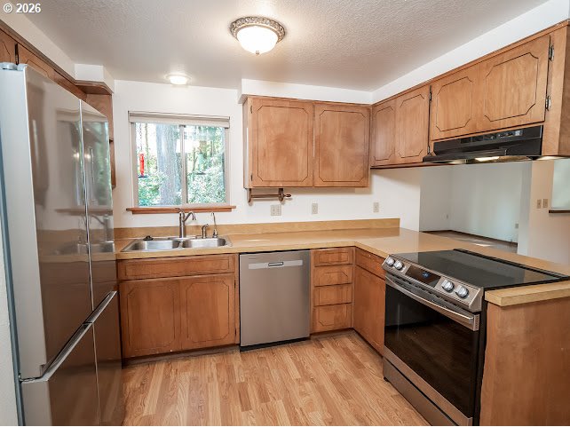 87974 8th Street Veneta, OR 97487 - Photo 23 of 48 a kitchen with stainless steel appliances granite countertop a stove a sink dishwasher and a refrigerator