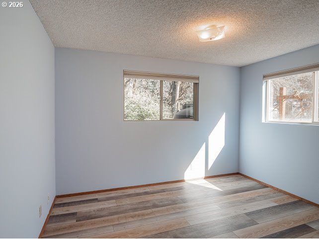 87974 8th Street Veneta, OR 97487 - Photo 34 of 48 an empty room with wooden floor cabinet and windows