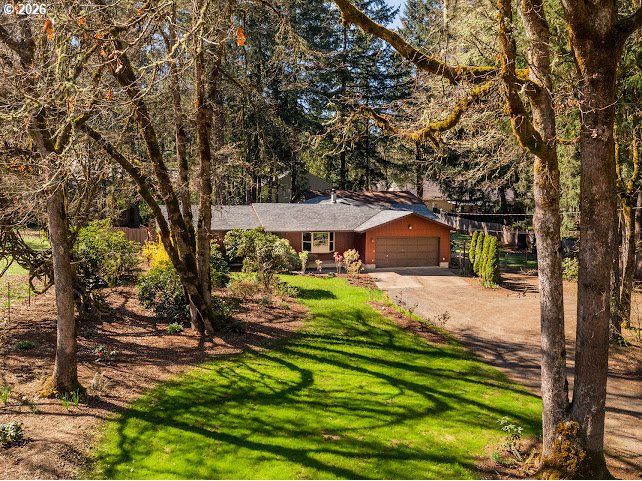 87974 8th Street Veneta, OR 97487 - Photo 5 of 48 a backyard of a house with table and chairs under an umbrella