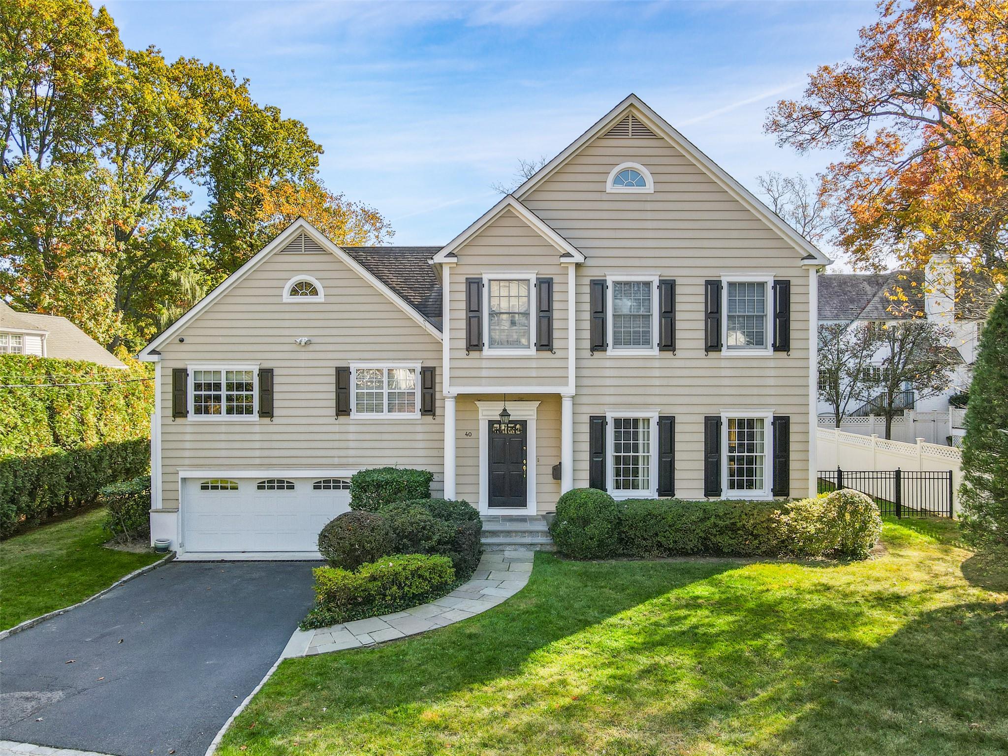 40 N Road Bronxville, NY 10708 - Photo 1 of 1 View of front of property with driveway, a garage, fence, and a front lawn