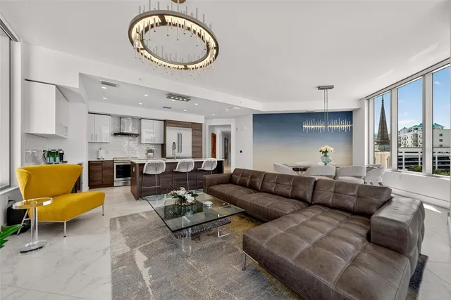 a living room with furniture and a floor to ceiling window