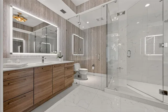 a bathroom with a toilet a sink and shower