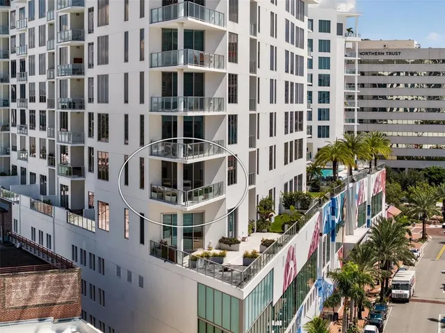 a living room with furniture and large windows