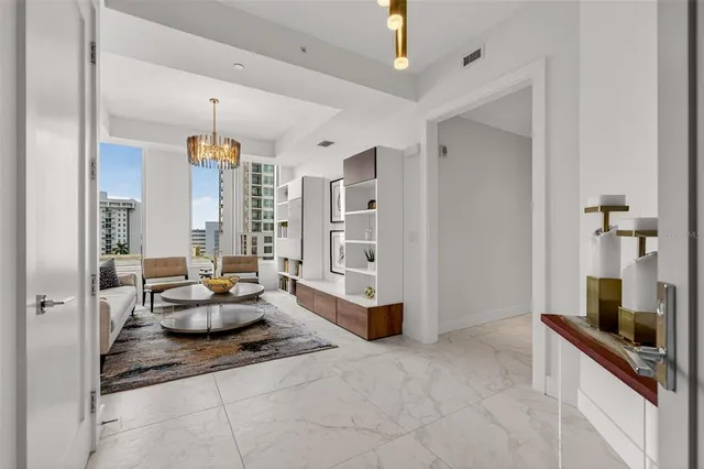 a living room with furniture and book shelf