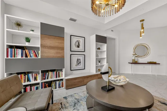 a large kitchen with stainless steel appliances a stove center island a window and chairs