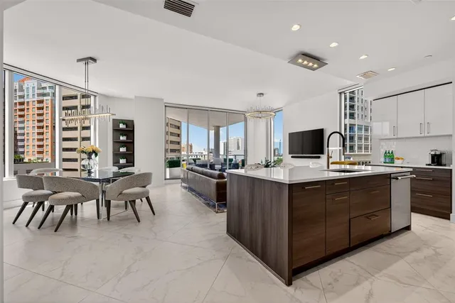 a living room with furniture kitchen view and a window