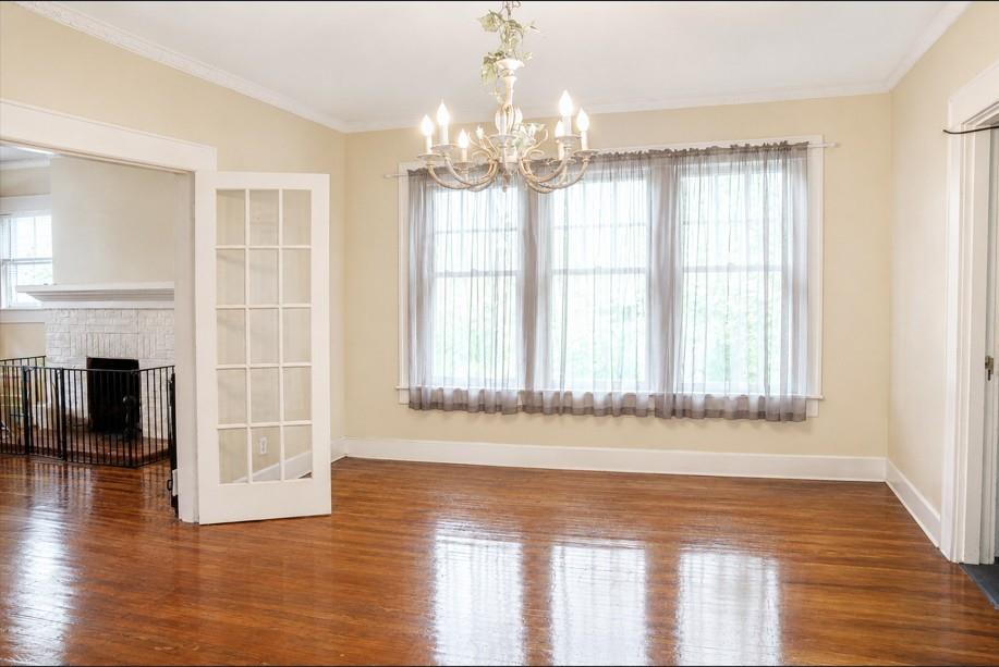 1500 Bonham Street Commerce, TX 75428 - Photo 5 of 29 a view of a room with wooden floor and a large window