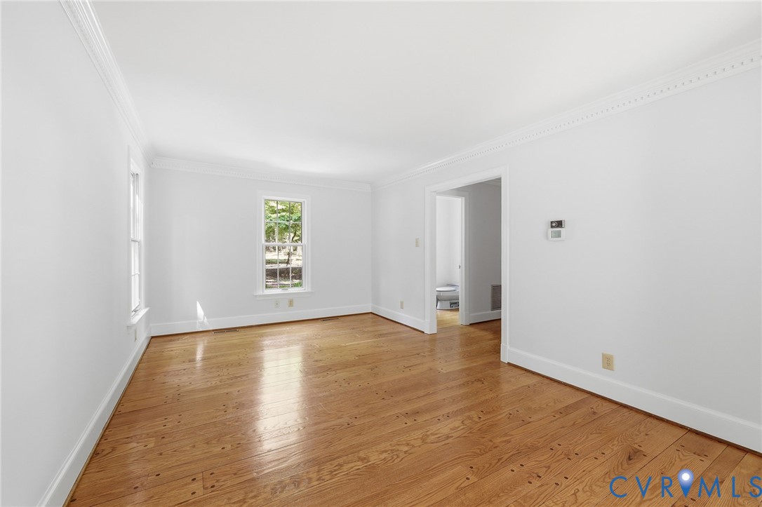 3201 East Brigstock Road Midlothian, VA 23113 - Photo 25 of 72 an empty room with wooden floor and windows