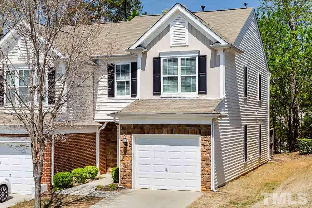 8722 Owl Roost Place Raleigh, NC 27617 - Photo 1 of 26 a front view of a house with a yard and garage