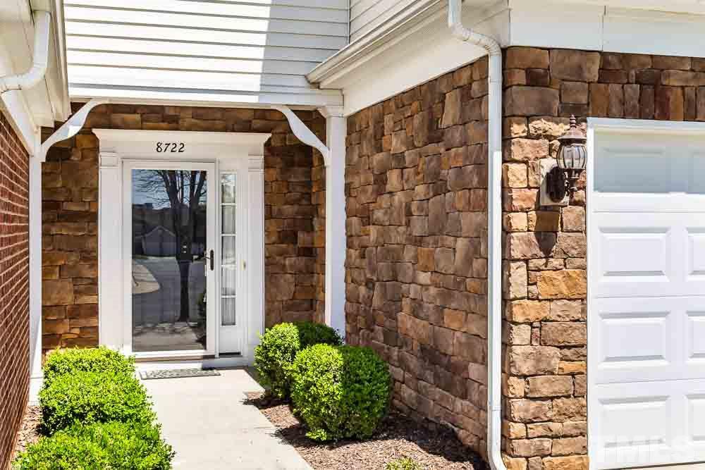 8722 Owl Roost Place Raleigh, NC 27617 - Photo 2 of 26 a front view of a building with a garden