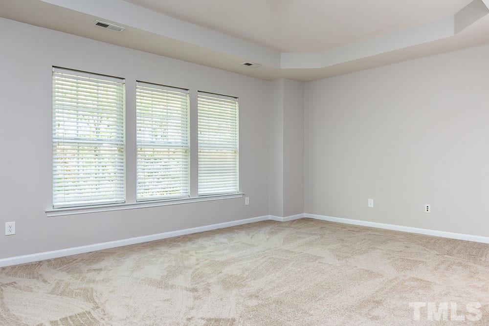 8722 Owl Roost Place Raleigh, NC 27617 - Photo 12 of 26 a view of an empty room with a window
