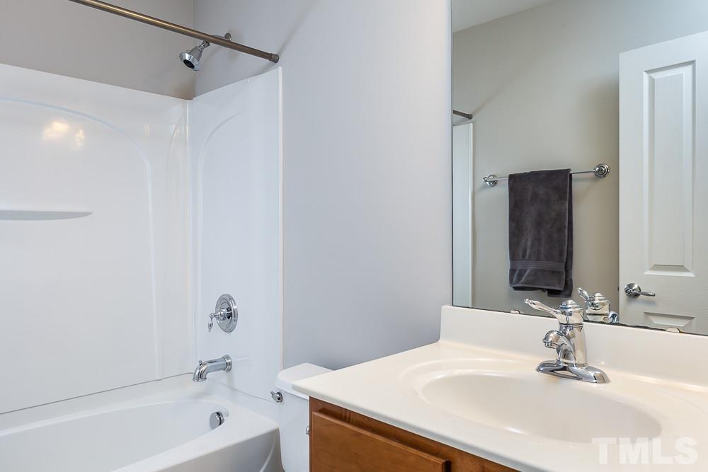 8722 Owl Roost Place Raleigh, NC 27617 - Photo 26 of 26 a bathroom with a sink and a mirror