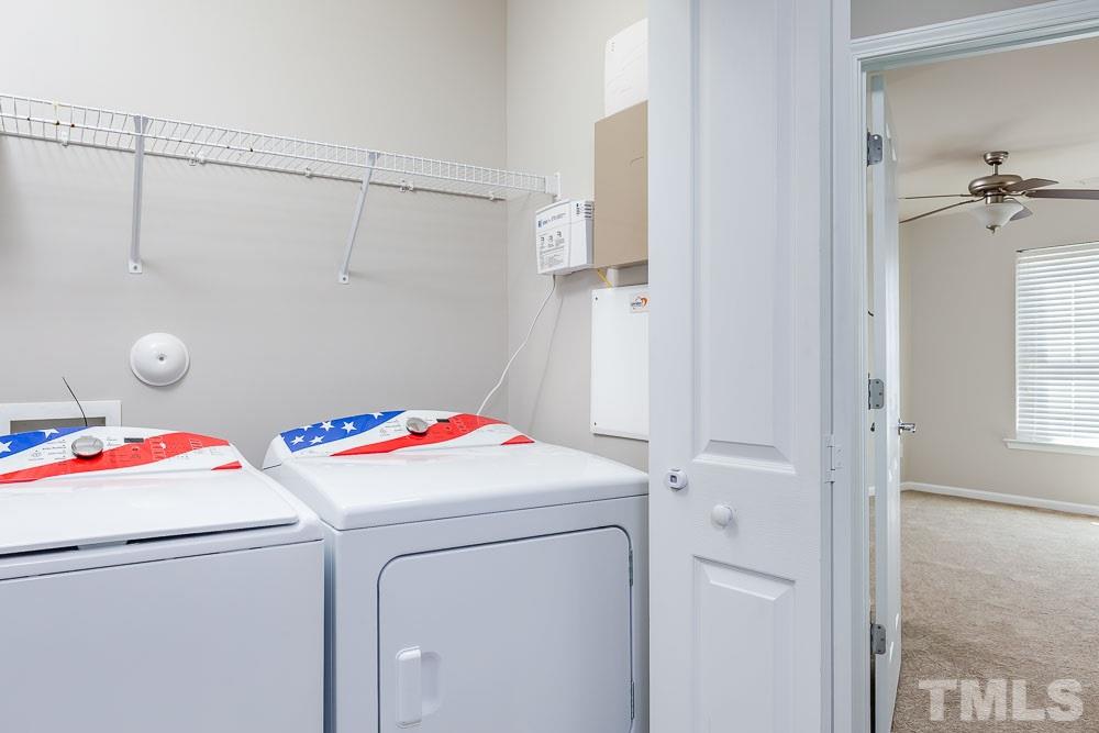 8722 Owl Roost Place Raleigh, NC 27617 - Photo 17 of 26 a utility room with dryer and washer