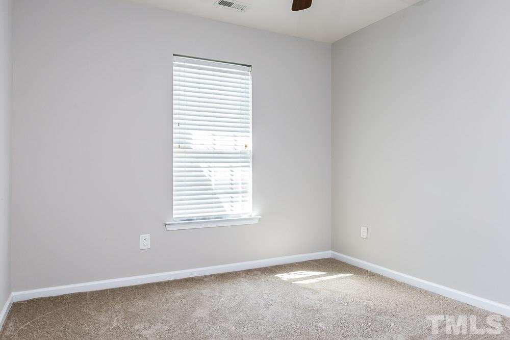 8722 Owl Roost Place Raleigh, NC 27617 - Photo 20 of 26 an empty room with a window