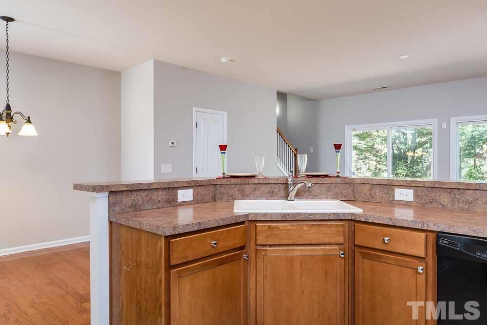 8722 Owl Roost Place Raleigh, NC 27617 - Photo 6 of 26 a kitchen with granite countertop a sink and a window