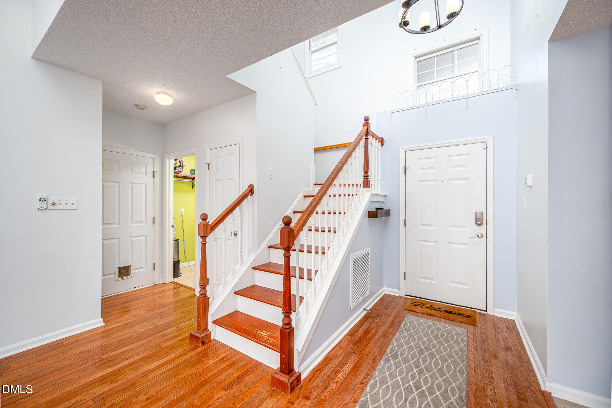 701 Thistlegate Trail Raleigh, NC 27610 - Photo 14 of 53 a view of entryway with wooden floor and stairs
