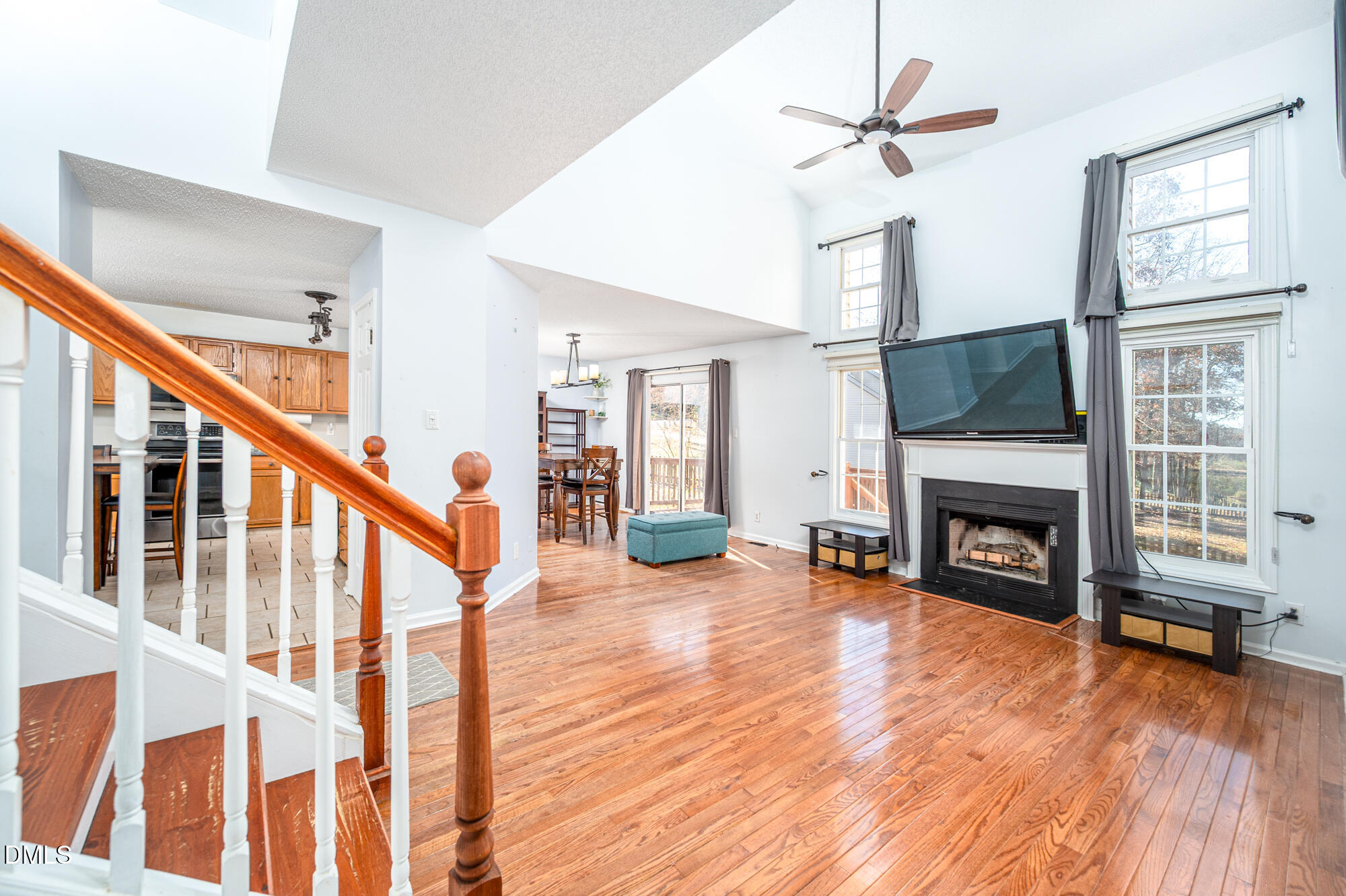 701 Thistlegate Trail Raleigh, NC 27610 - Photo 18 of 53 a view of a livingroom with fireplace a ceiling fan and windows