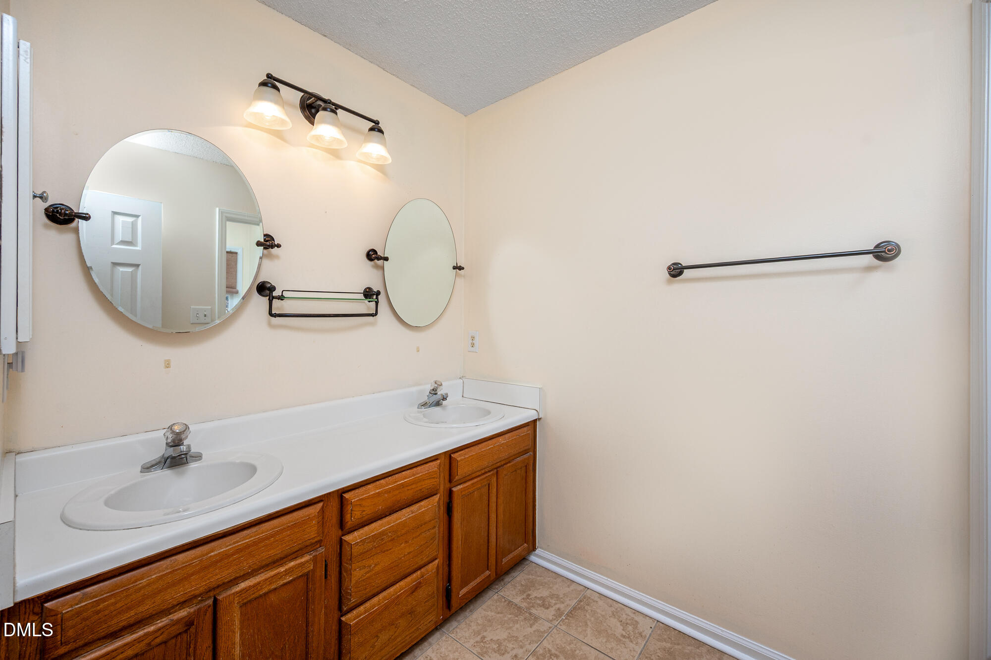 701 Thistlegate Trail Raleigh, NC 27610 - Photo 33 of 53 a bathroom with a double vanity sink and a mirror