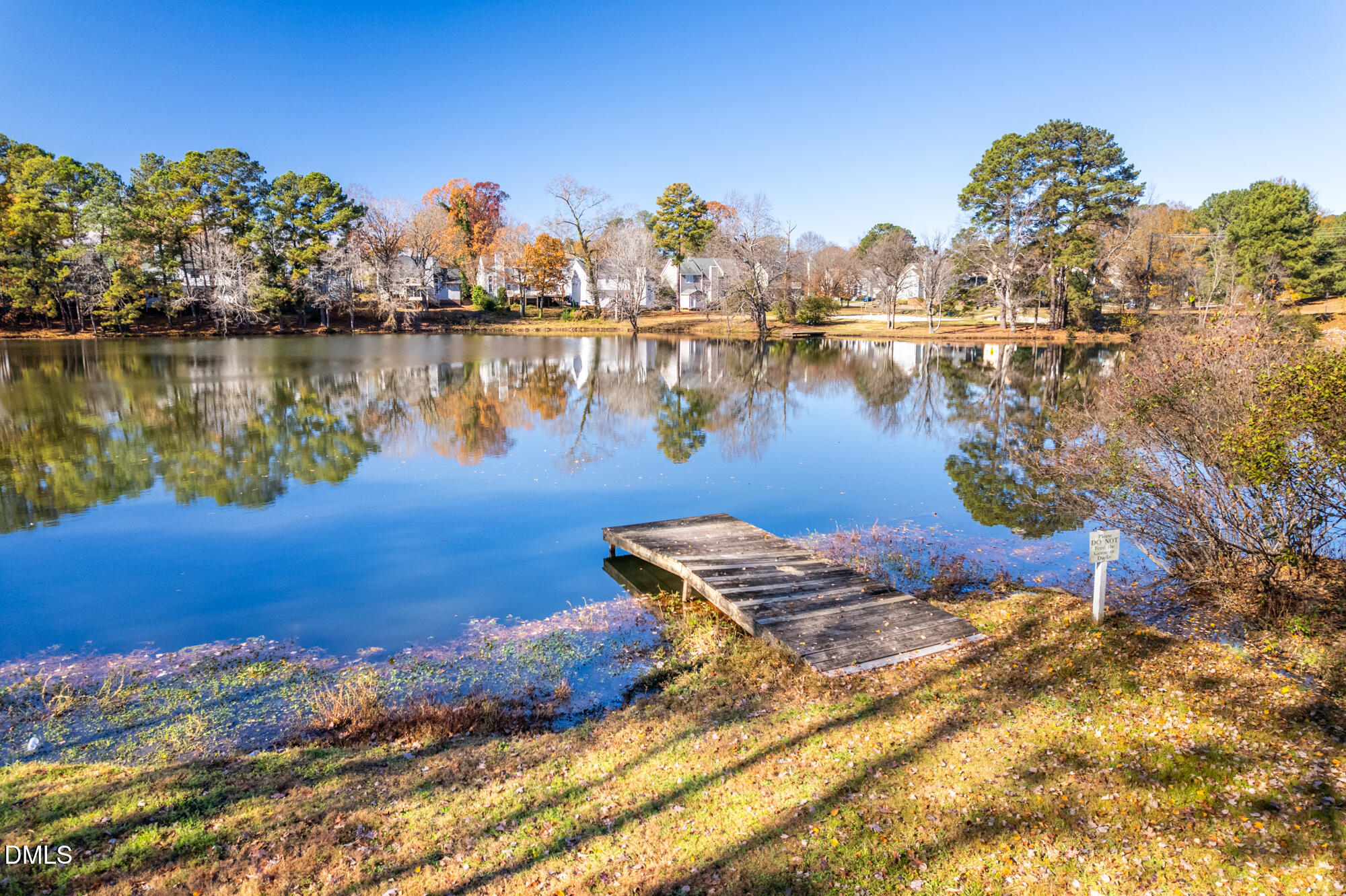 701 Thistlegate Trail Raleigh, NC 27610 - Photo 45 of 53 a view of a lake with houses in the back