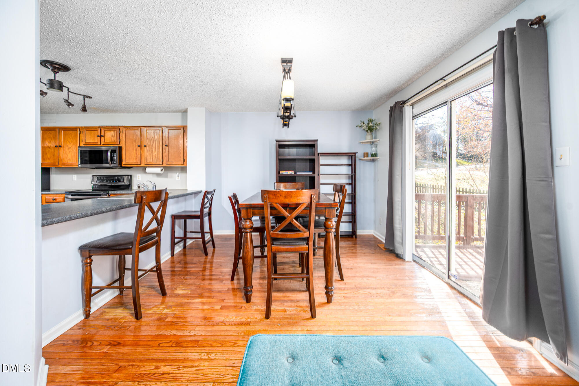 701 Thistlegate Trail Raleigh, NC 27610 - Photo 9 of 53 a dining room with furniture a chandelier and wooden floor